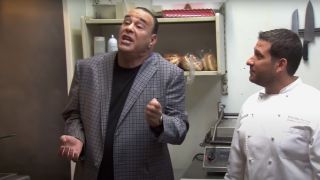 Jon Taffer stands in a kitchen in a heated conversation in Bar Rescue.